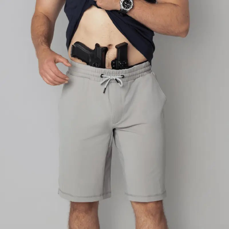 Man with gun and magazine in waistband wearing Carrier Shorts Mk.II for concealed carry