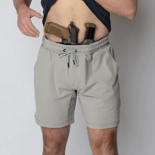 Man with gun in waistband wearing Arrowhead Tactical Apparel Carrier Shorts Mk.II