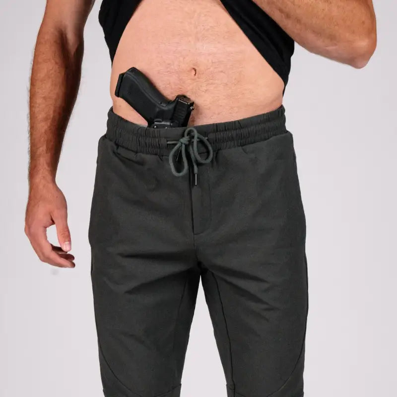 Man with concealed carry gun in waistband wearing Carrier Traveler Joggers with carrier retention waistband