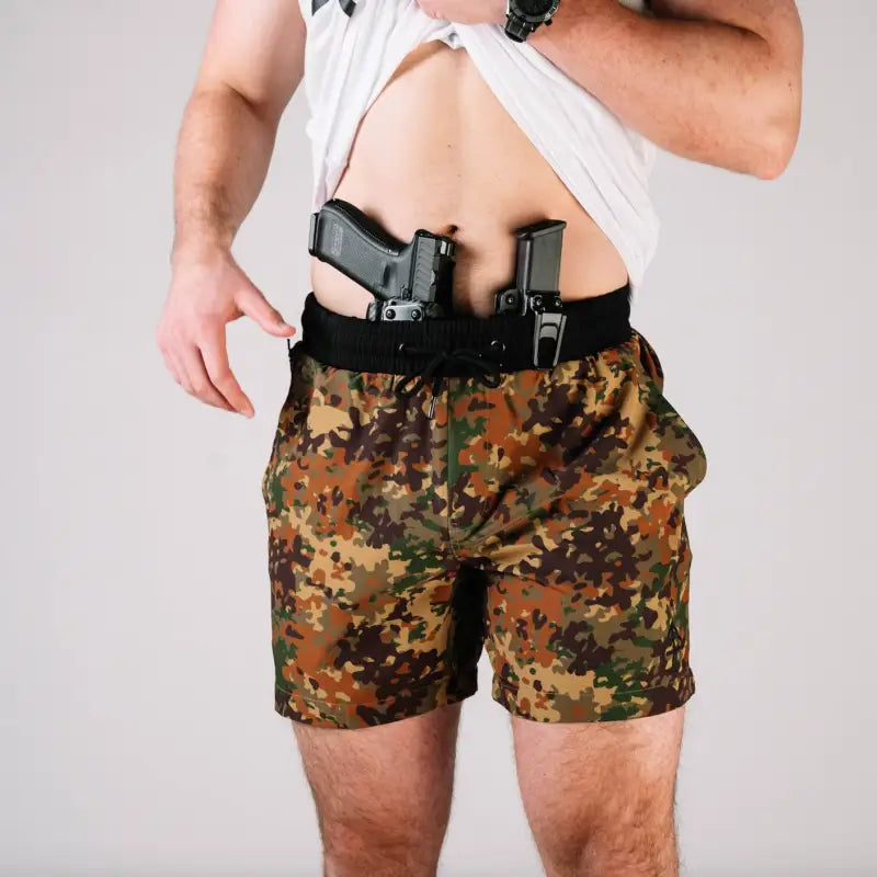 Man wearing Carrier Training Shorts 5 Inseam with concealed carry guns in waistband