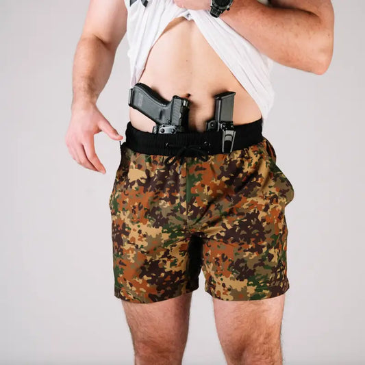 Man wearing Carrier Training Shorts 5 Inseam with concealed carry guns in waistband
