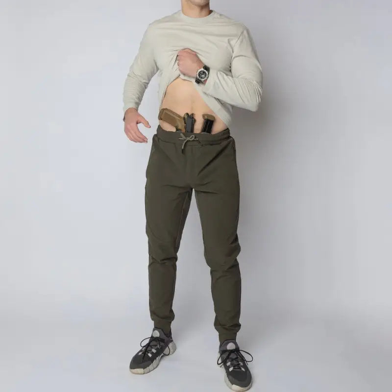 Man with concealed carry in carrier retention waistband of Carrier Traveler Joggers