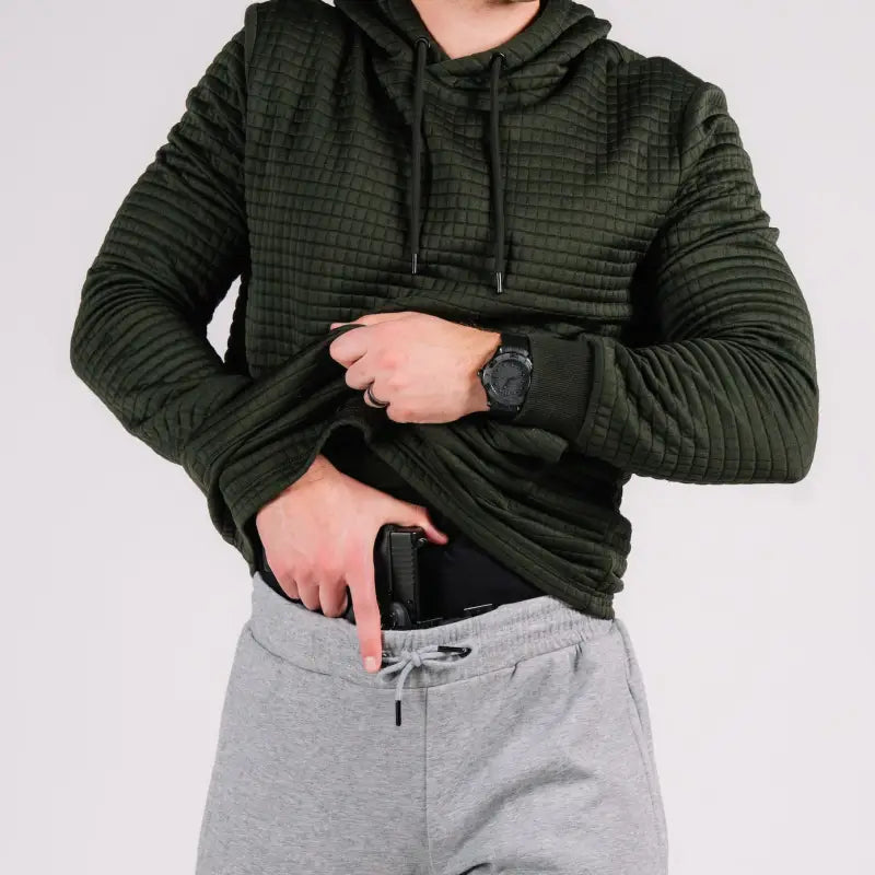 Man concealing handgun in hand pocket of Standoff Concealment Hoodie Mk.II for standoff concealment