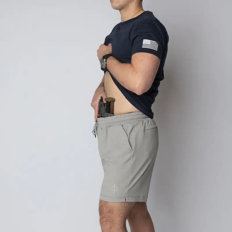 Man concealing handgun in shorts from Arrowhead Tactical Apparel’s Carrier Shorts Mk.II