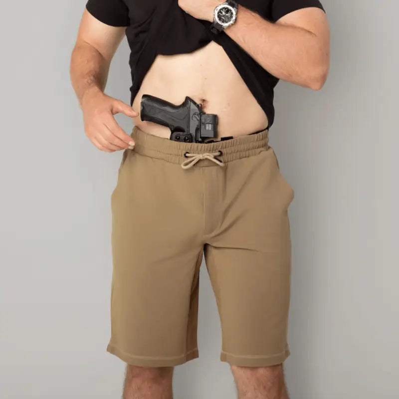 Man concealing handgun in Carrier Shorts Mk.II for concealed carry by Arrowhead Tactical Apparel