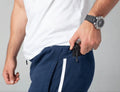 Man placing folding knife in pocket with Carrier Joggers Mk.II for concealed carry and retention