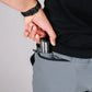 Man inserting magazine into pocket of Carrier Shorts Mk.II for concealed carry by Arrowhead Tactical Apparel