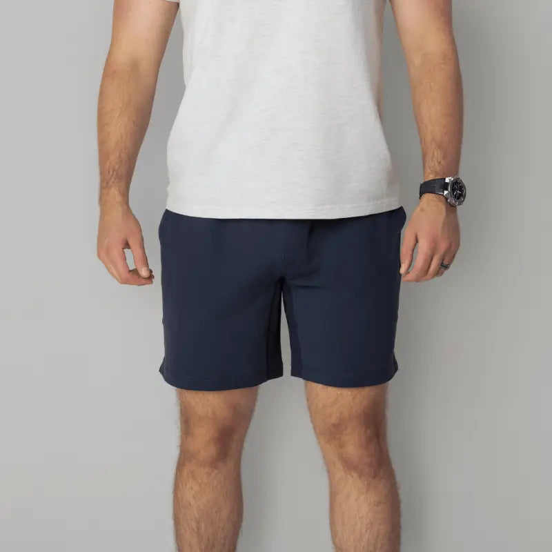 Man wearing navy Carrier Shorts Mk.II with 7-inch inseam from Arrowhead Tactical Apparel