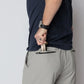 Man inserting wallet into zippered pocket on Carrier Shorts Mk.II for concealed carry by Arrowhead Tactical Apparel