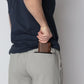 Man placing wallet in zippered pocket of Carrier Shorts Mk.II for concealed carry, Arrowhead Tactical Apparel