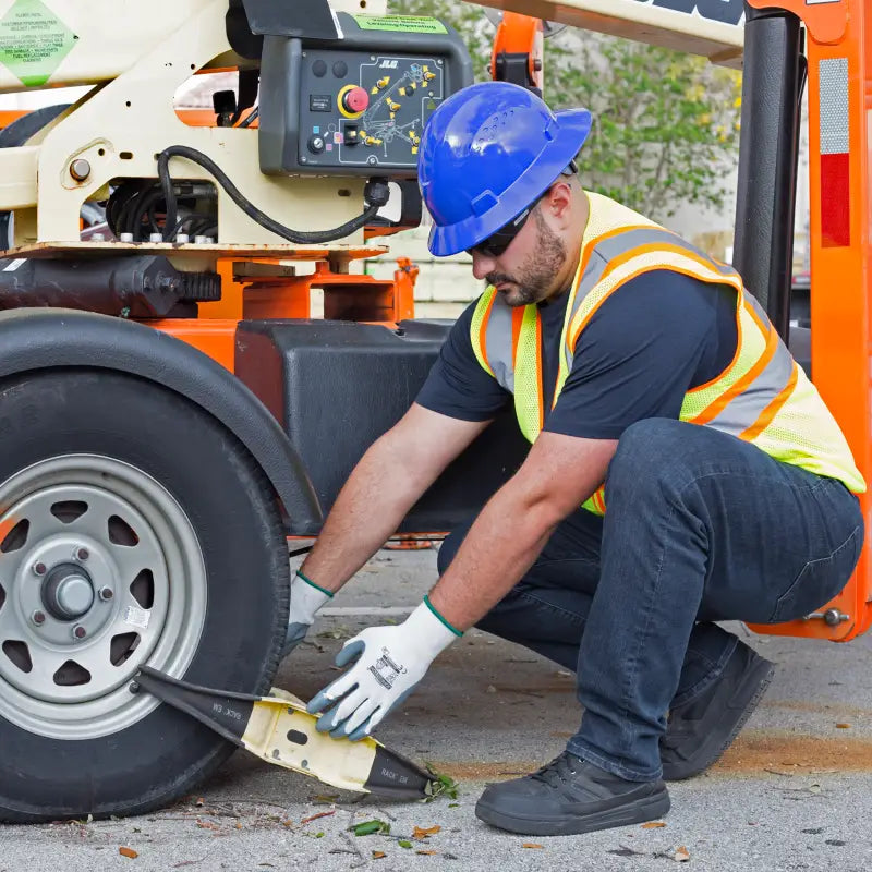 Man installing wheel chock while wearing Full Brim Safety Hard Hat with 4 Point Suspension