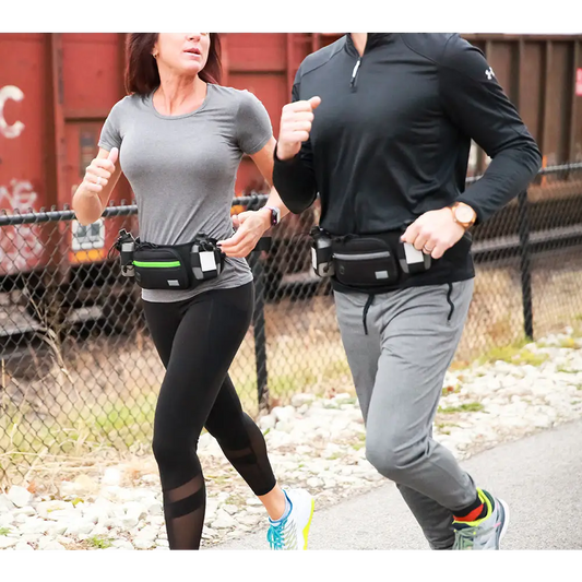 Two runners with fanny packs jogging together, featuring the Marathon Gun Pack