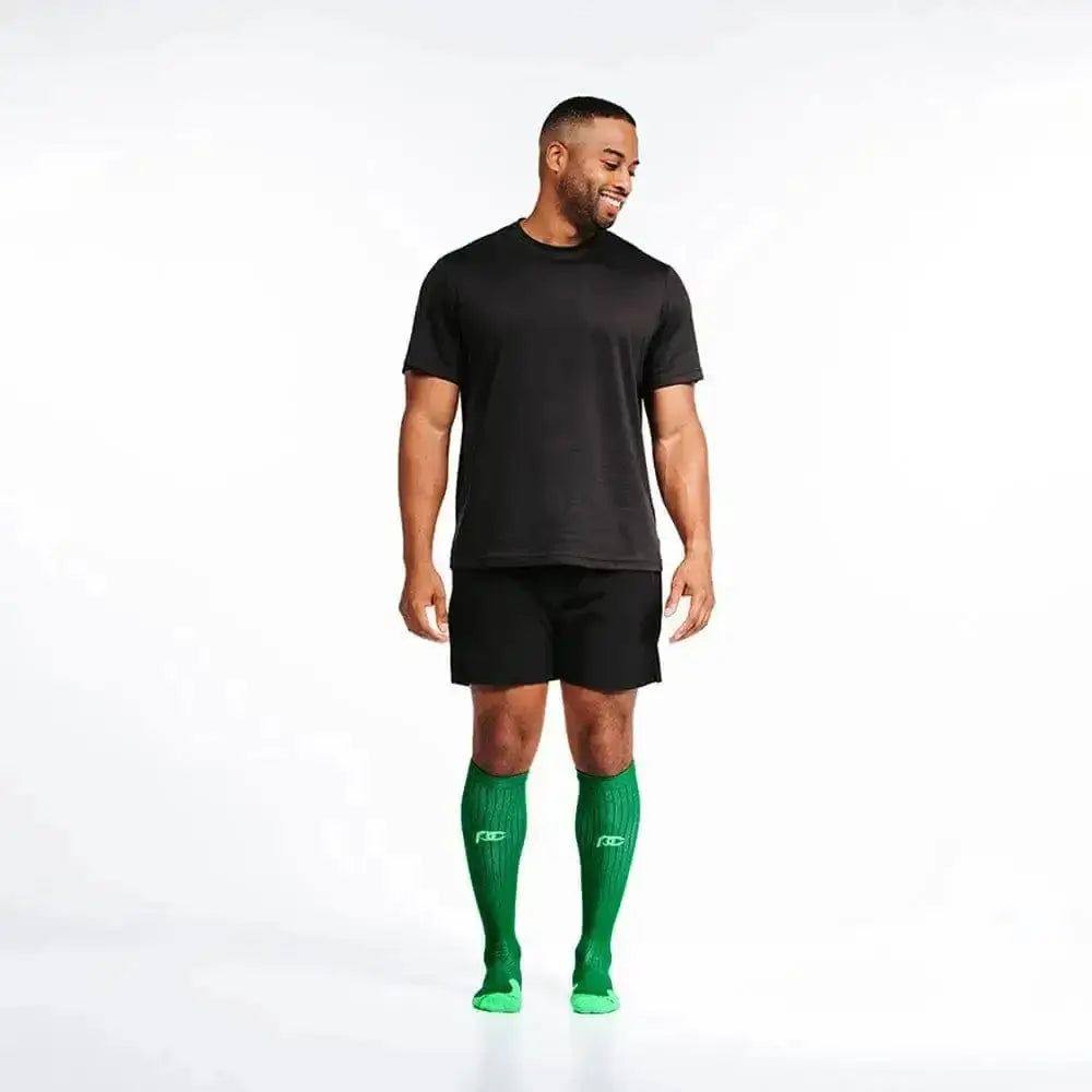 Athletic figure in black gear and bright Kelly Green compression socks for first responders