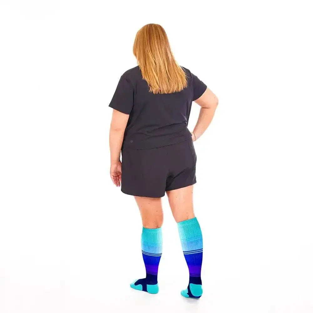 Person in black romper and colorful striped compression socks, Marathon Wide-Calf, Minnesota Lakes