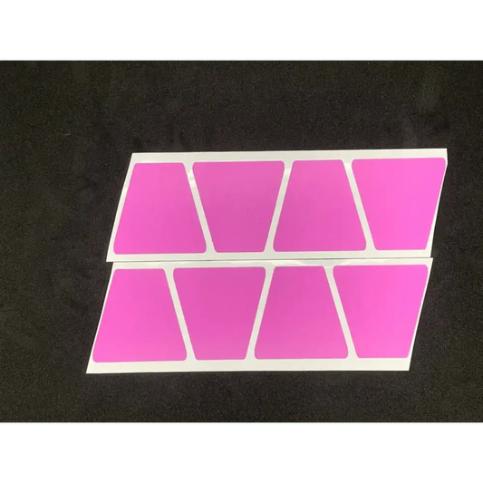 Eight pink trapezoid shapes for the Matte Pink Reflective Helmet 8 Pack on a white surface