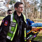 Emergency Medical Technician with MCHD ANSI II Adjustable Vest and stretcher in action