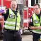 Two emergency responders in high-visibility MCHD ANSI II Adjustable Vests near fire truck