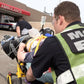 EMT personnel using MCHD ANSI II Adjustable Vest transport patient to an ambulance bay