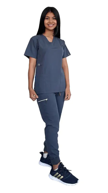 Medical professional in navy blue scrubs and black shoes wearing Stretch Slim Fit Zipper Jogger Uniform