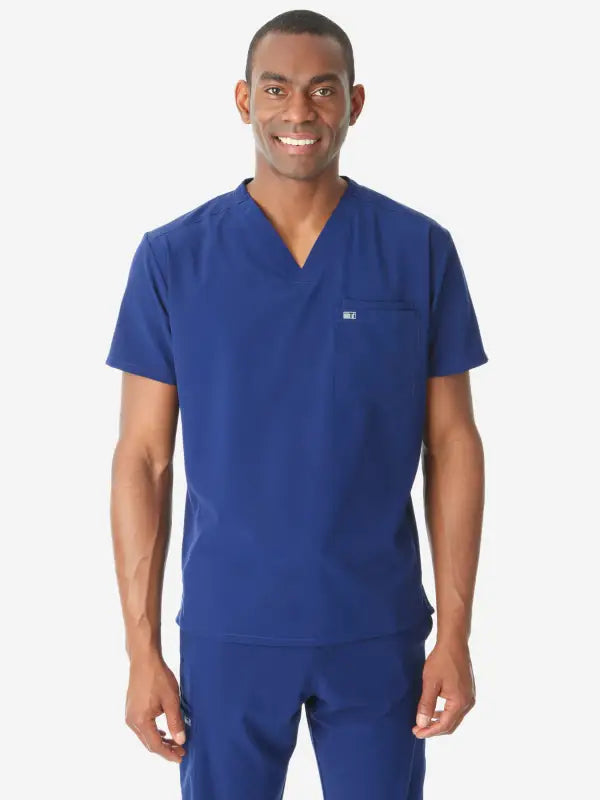 Medical professional in royal blue men’s double-pocket scrub top demonstrating style and comfort