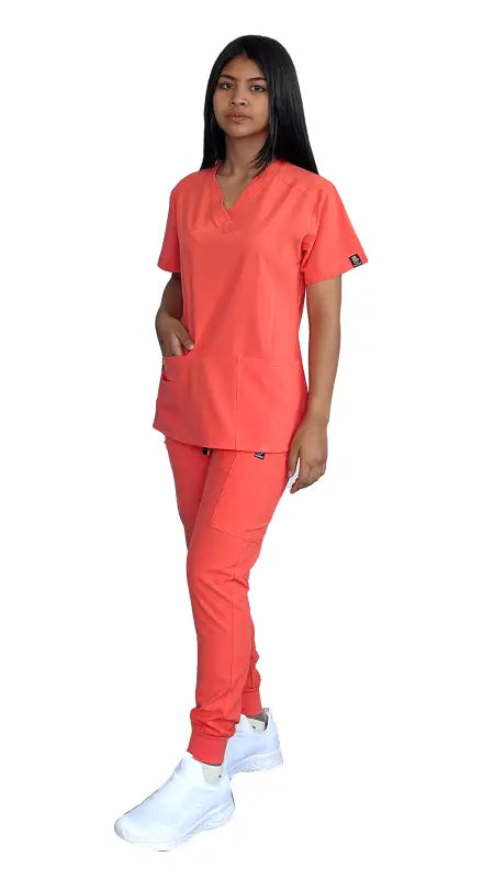 Women’s Stretch Slim Fit Zipper Jogger Uniform in coral with white sneakers