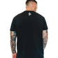 Black Men’s Gym Tee Compellence worn by a tattooed individual with an American flag design