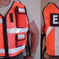 High-visibility orange safety reflective vest with E.O.D. patches and reflective stripes