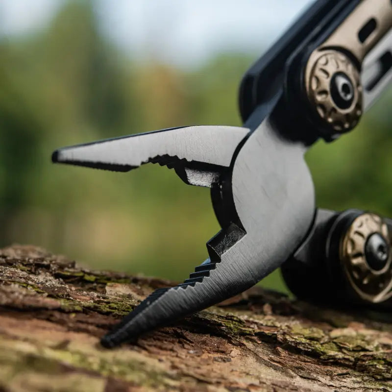 Metal pliers with black handles on bark, featured in M-Tac Multitool Type 5 Olive