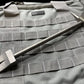 Metal pry bar tool with forked ends on gray tactical fabric for Hooligan Forced Entry