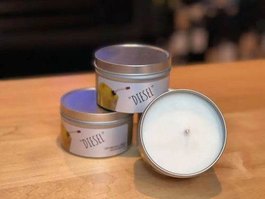 Metal tin candles with Diesel labels showcasing Diesel scented candle for truck enthusiasts