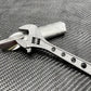 Metallic adjustable wrench with drilled handle holes - Titanium 6 Inch NSN Pending