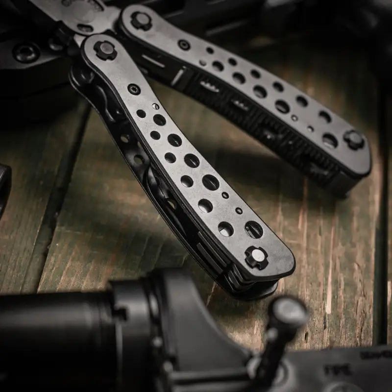 Metallic butterfly knife with perforated handles in M-Tac Multitool Type 1 rubber case