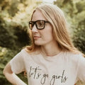 Person in glasses and white t-shirt showcasing Metel M40 Safety Glasses with polycarbonate lenses