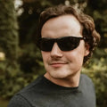 Person wearing Metel M40 Safety Glasses with polycarbonate lenses and a dark t-shirt