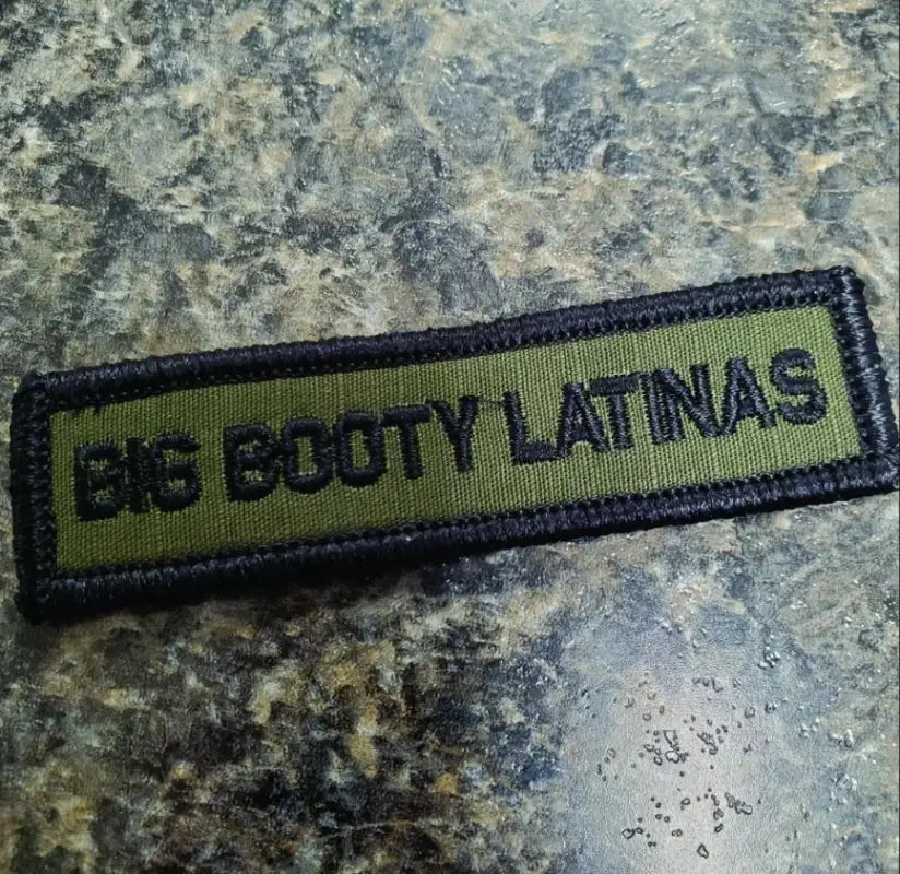 Military morale patch featuring ’Big Booty Latinas’ in black on olive drab fabric