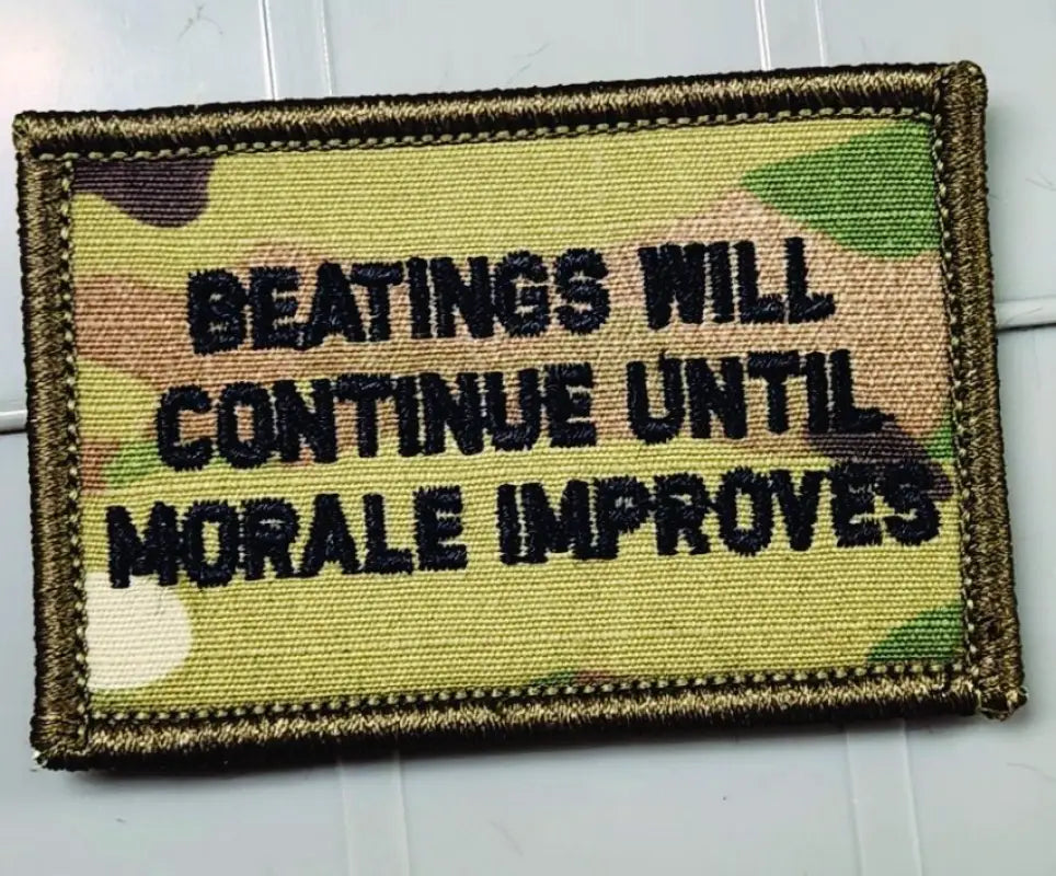 Military morale patch in Multicam w blk, reading Beatings Will Continue Until Morale Improves