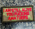 Military-style patch - Multicam w red text I AM STILL ALIVE YOU FUCKING AMATUERS 2x4 patch