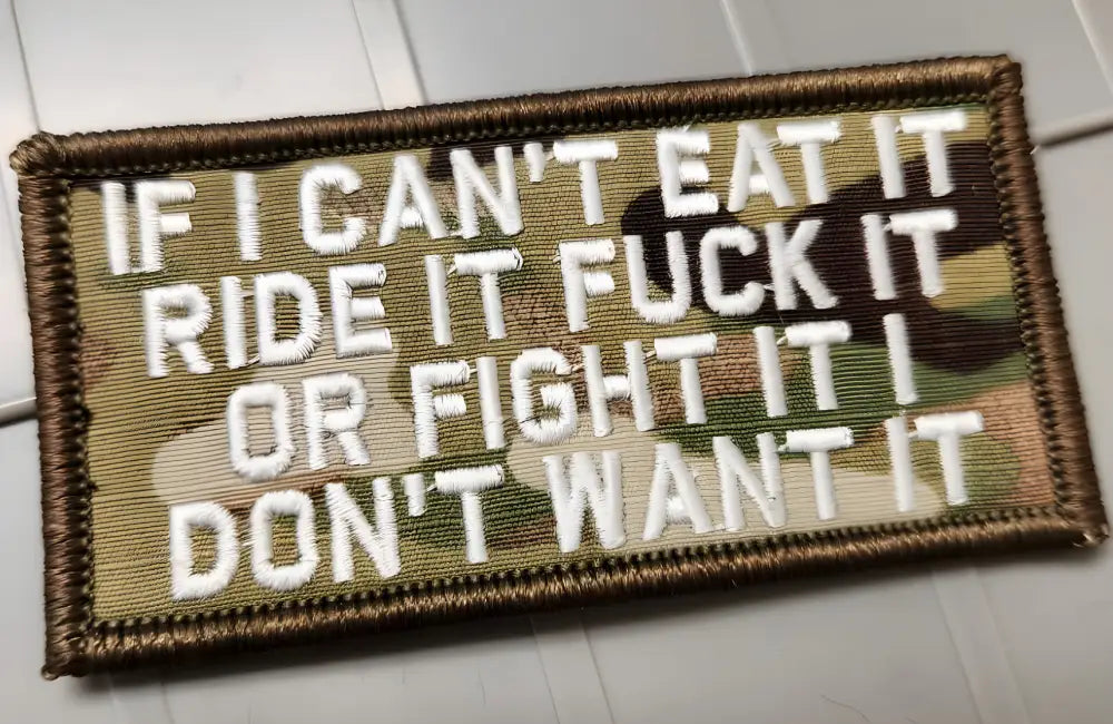 Military-style multicam w white morale patch featuring a crude statement about priorities