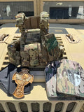 Military-style tactical vest with camouflage, American flag patch, tactical gloves, body armor