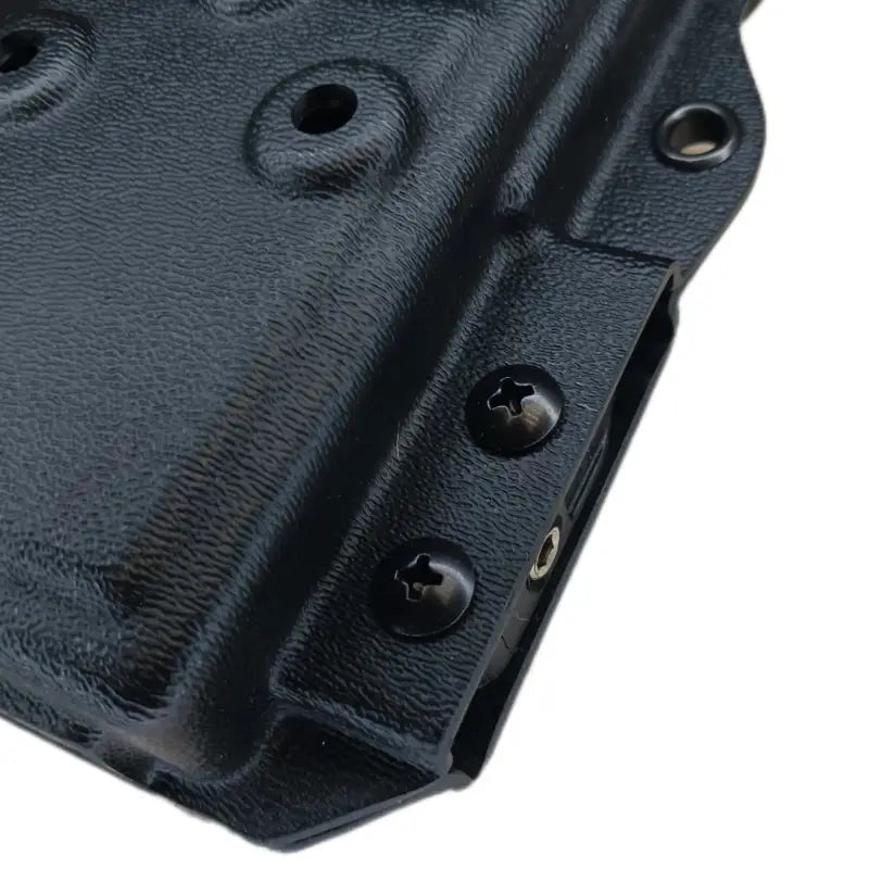 Black textured holster for Motorola APX 8000 with mounting screws and rivets