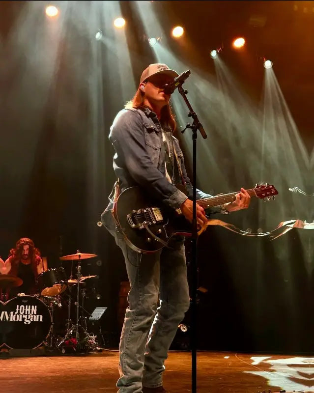 Musician in Knox Hat performing on stage with electric guitar, honoring first responders