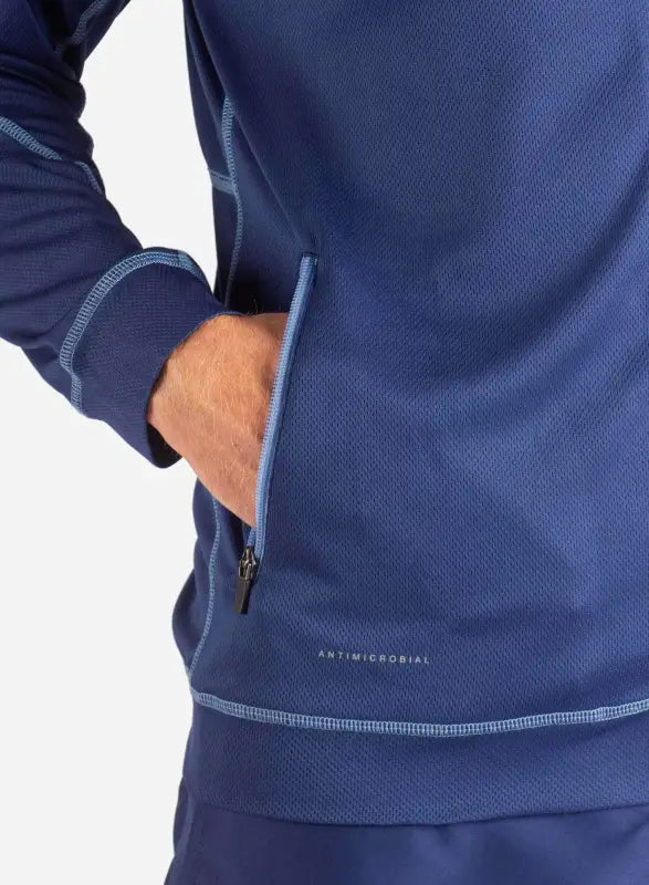 Navy blue men’s scrub jacket featuring contrast stitching and zippered pocket