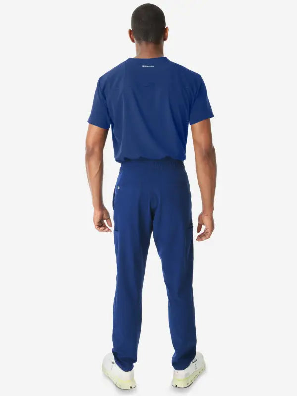 Navy blue athletic outfit featuring Men’s Double-Pocket Scrub Top and jogger pants