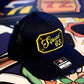 Navy blue Richardson 112 cap with yellow Squad 63 patch and passport cursive lettering design