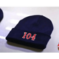 Navy blue two color beanie with red 104 numbers embroidered on the front