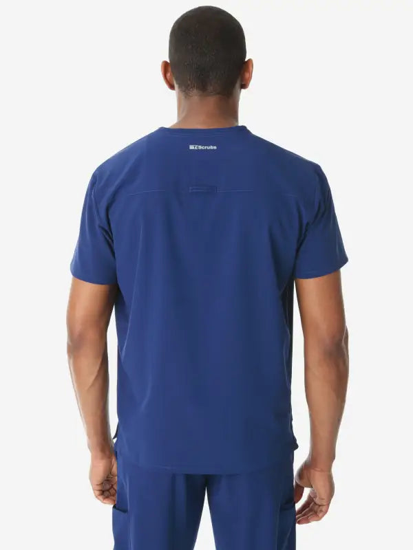 Navy blue men’s double-pocket scrub top viewed from the back for healthcare professionals