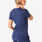 Navy blue women’s tuckable one-pocket scrub uniform shown from the back view