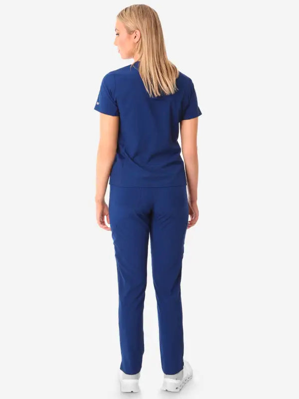 Navy blue women’s stash-pocket scrub uniform with short sleeves and full-length pants