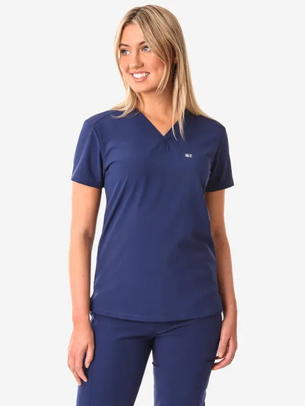 Navy blue women’s tuckable one-pocket scrub top with V-neck design