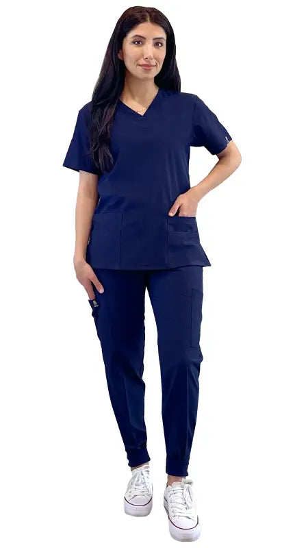 Navy blue Women’s 4-Way Extreme Stretch Jogger Scrubs with white sneakers displayed